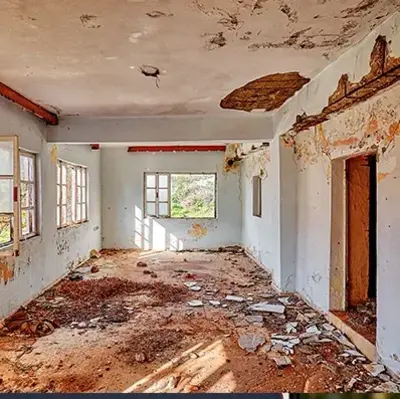 A close-up view of a dirty floor with visible dirt and debris scattered across the surface.