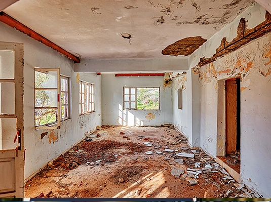 A close-up view of a dirty floor with visible dirt and debris scattered across the surface.