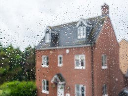 looking at house through rainy window